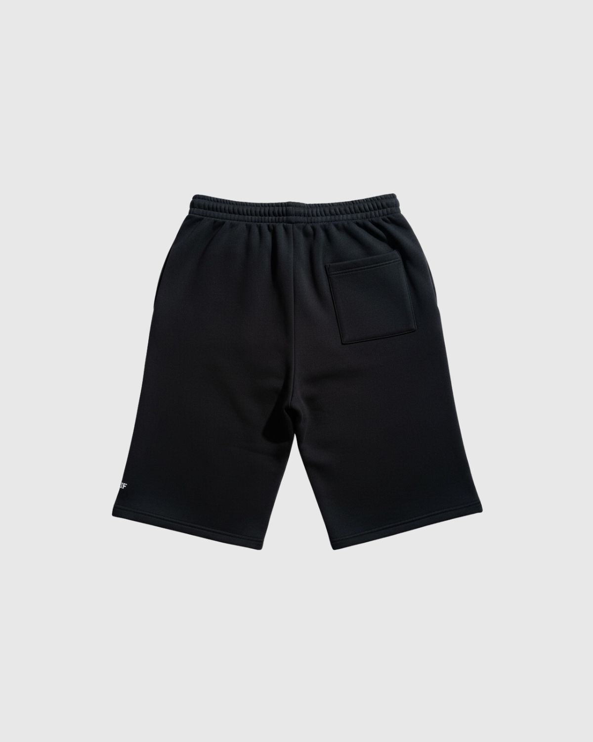 Back of long fleece shorts with patch pocket on a light gray background (Black)