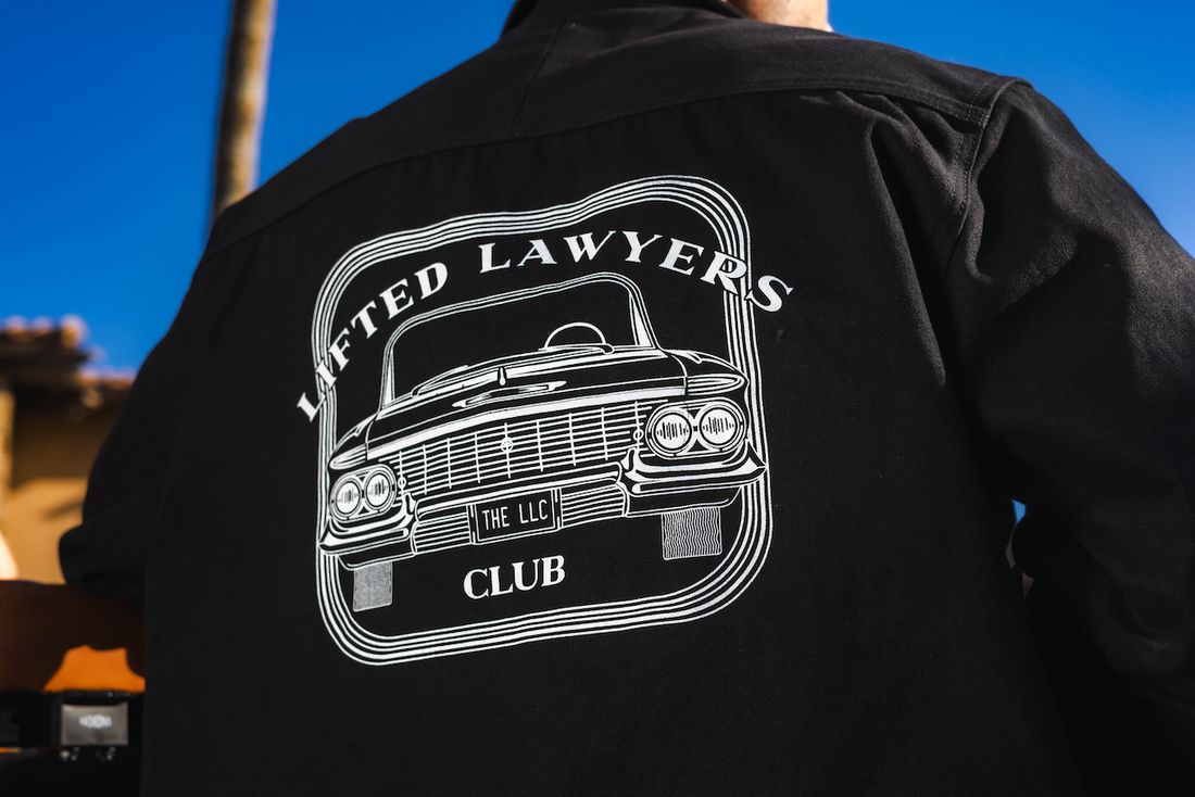 Lifted Lawyers Club (The LLC) Zip Jacket back image of a lowrider car with THE LLC in the license plate